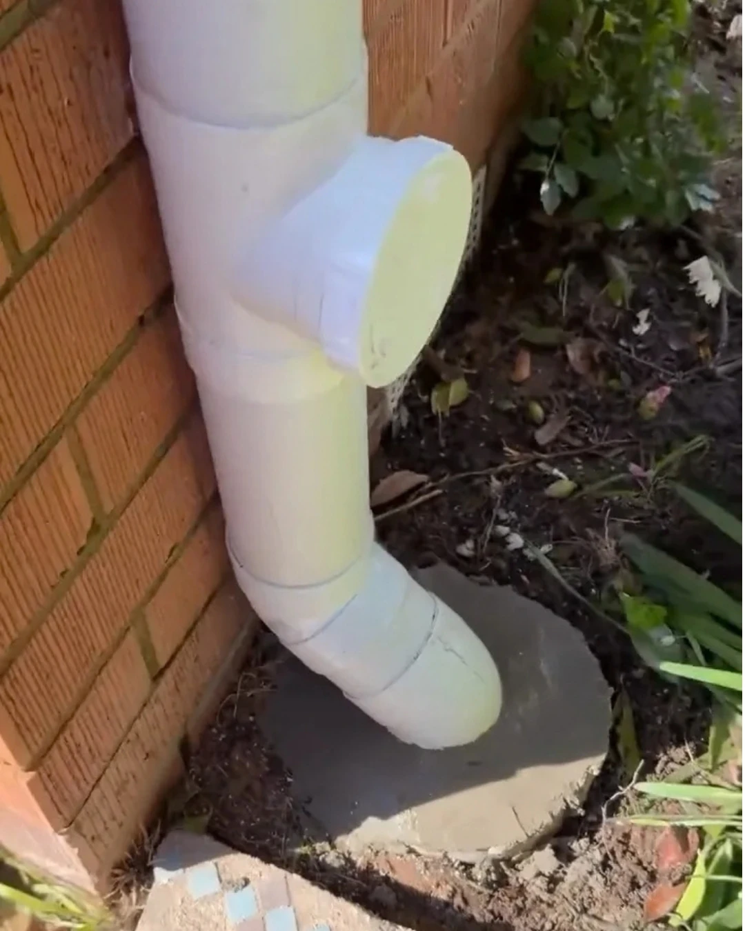 New white PVC stormwater downpipe with an inspection opening in Torrens