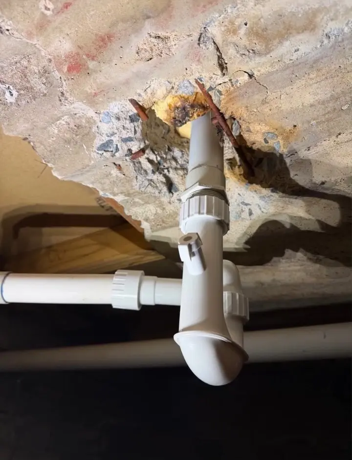 Complete new bath-drainage setup installed beneath the subfloor after the failed joint was removed