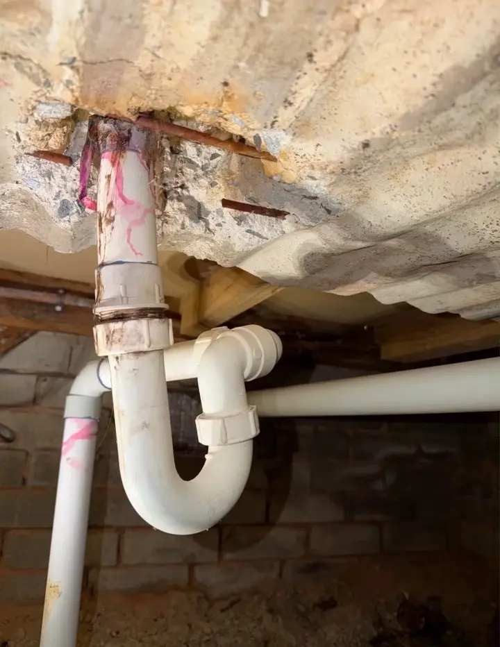 Failed joint in the bath drainage beneath the subfloor before repair